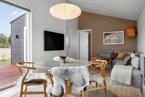 a living room with a table and chairs and a couch at LF13025-Oster-Assels-Kanalstien-3 in Øster Assels