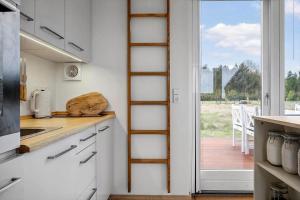 a kitchen with a ladder next to a window at LF13025-Oster-Assels-Kanalstien-3 in Øster Assels +20 photos