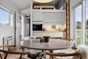 a kitchen and dining room with a table and chairs at LF13025-Oster-Assels-Kanalstien-3 in Øster Assels