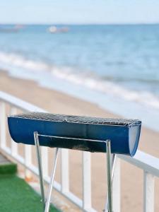 a blue bench on a railing near the beach at Gao Check in Phala Beach Front in Rayong +20 photos