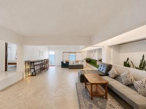 a living room with a couch and a table at Gao Check in Phala Beach Front in Rayong