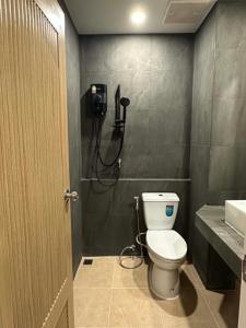a bathroom with a white toilet and a shower at Tokyo Hotel in Ubon Ratchathani
