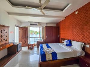 a bedroom with a large bed in a room at Captains Cabin, Alleppey- A Premium Backwater Mansion in Alleppey +47 photos