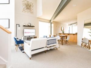 a large room with two beds and a dining area at Upscale 3BR Penthouse by CozySuites in Indianapolis
