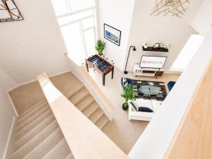 an overhead view of a staircase in a living room at Upscale 3BR Penthouse by CozySuites in Indianapolis