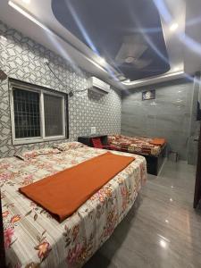 a bedroom with two beds and a blue ceiling at Aditya Residency in Mādhavaram +4 photos