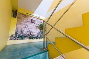 a staircase in a building with a mural on the wall at Pachumas Hotel in Karon Beach