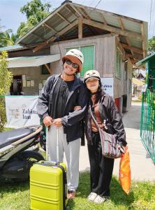 a man and a woman standing with a suitcase at Little Zabina Inn in San Juan