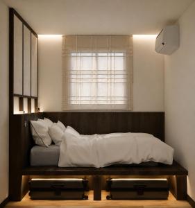 a bed sitting in a room with a window at Stay Damyeon in Seoul