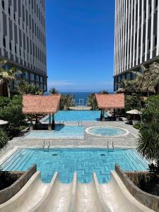a swimming pool in the middle of two tall buildings at Mandala Twilight Haven 5 Star in Phan Thiet