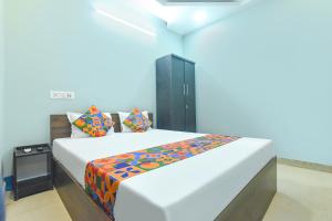 a bedroom with a large white bed in a room at FabHotel Taj Palace in kolkata