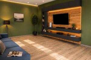 a living room with a tv and a blue couch at Villa in Mayak in Baku