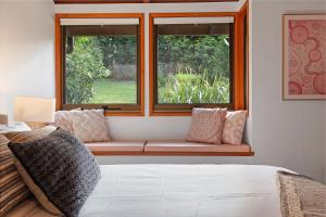 a window seat in a room with a bed at Hinterland family getaway in Maleny +53 photos