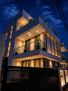 a large building with lights on at night at KIGALi WHITE HOMES AND RESIDENCE in Kigali