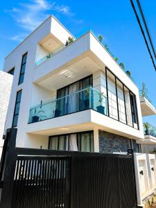 a white house with a black fence in front of it at KIGALi WHITE HOMES AND RESIDENCE in Kigali