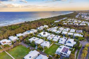 an aerial view of a resort next to the ocean at The Art House at Beachside in Yaroomba