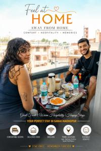 a man and woman sitting on a balcony eating breakfast at Hotel Sawai View in Sawāi Mādhopur