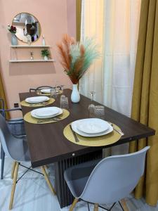 a dining room table with two chairs and a mirror at Royal Zam Résidence in Ouagadougou +41 photos