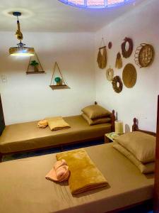 two beds in a room with baskets on the wall at Maliag Studio Type Room for Rent in Coron