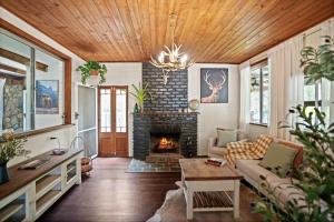 a living room with a couch and a fireplace at Bellbird Rise Off-Grid Cottage in Conondale