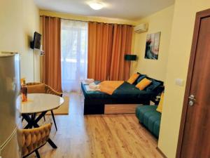 a living room with a couch and a table at One-room boutique at Sunrise All Suites in Obzor