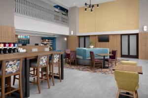 a large lobby with a bar and chairs at Hampton Inn & Suites Lake City in Lake City