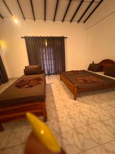 a living room with two beds and a couch at Serendib Villa Mirissa in Mirissa