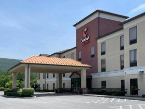 a hotel with a parking lot in front of it at Comfort Suites Altoona North in Altoona