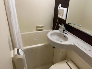 a small bathroom with a sink and a toilet at Comfort Hotel Shin Yamaguchi in Yamaguchi