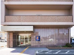 a building with a sign on the side of it at Comfort Hotel Hachinohe in Hachinohe