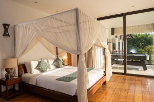 a bedroom with a bed with a canopy at Akilea Villas Bali in Uluwatu +44 photos