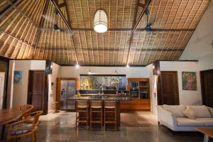 a living room with a couch and a table at Akilea Villas Bali in Uluwatu