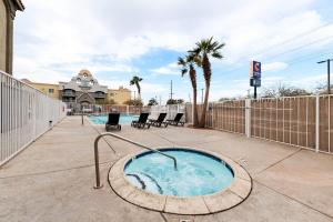 a hot tub on a patio with chairs and a fence at MainStay Suites El Centro I-8 in El Centro