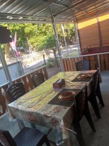 a table and chairs in a tent with a table at STELAMARIS HomeStay in Pulau Bunaken