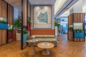 a lobby with a couch and a table at Hilton Garden Inn Rome Colosseum in Rome