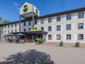 a hotel with a sign on the front of it at B&B HOTEL Regensburg-Ost in Regensburg +19 photos