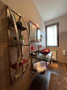 a bathroom with a sink and a mirror on the wall at Regina House Vigevano in Vigevano