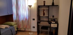 a bedroom with a bed and a desk and a chair at Regina House Vigevano in Vigevano +9 photos