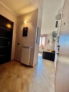a living room with a couch and a hallway at Regina House Vigevano in Vigevano
