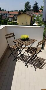 a table and two chairs sitting on a balcony at Regina House Vigevano in Vigevano