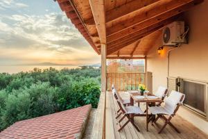 a patio with a table and chairs on a deck at Selinitsa Stone Studio - Mani Seaview Retreat in Agios Nikolaos