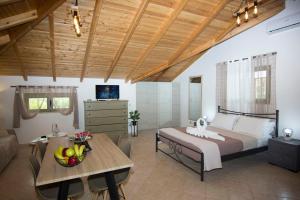 a bedroom with a large bed and a table at Selinitsa Stone Studio - Mani Seaview Retreat in Agios Nikolaos