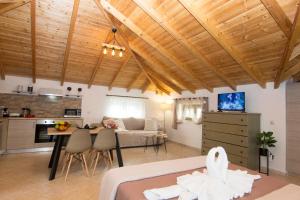 a room with a bed and a kitchen and a living room at Selinitsa Stone Studio - Mani Seaview Retreat in Agios Nikolaos