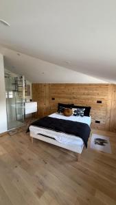 a bedroom with a large bed and wooden walls at Maison cosy climatisée in Bar-le-Duc