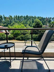 a chair and a table on a balcony at Sunny Siviri in Siviri