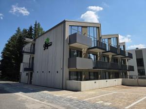 a building with balconies on the side of it at APLEND Aparthotel Litvor in Štrba