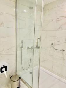 a bathroom with a shower with a glass door at Batumi High View in Batumi +58 photos