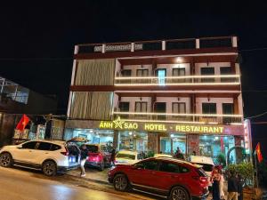 a group of cars parked in front of a hotel at Ánh Sao Sapa Hotel in Sapa