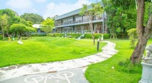 a building with a path in front of a park at Doembang Villa in Ban Tha Pong