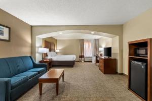 a living room with a couch and a bed in a hotel room at Comfort Inn & Suites Panama City - St Andrew in Panama City